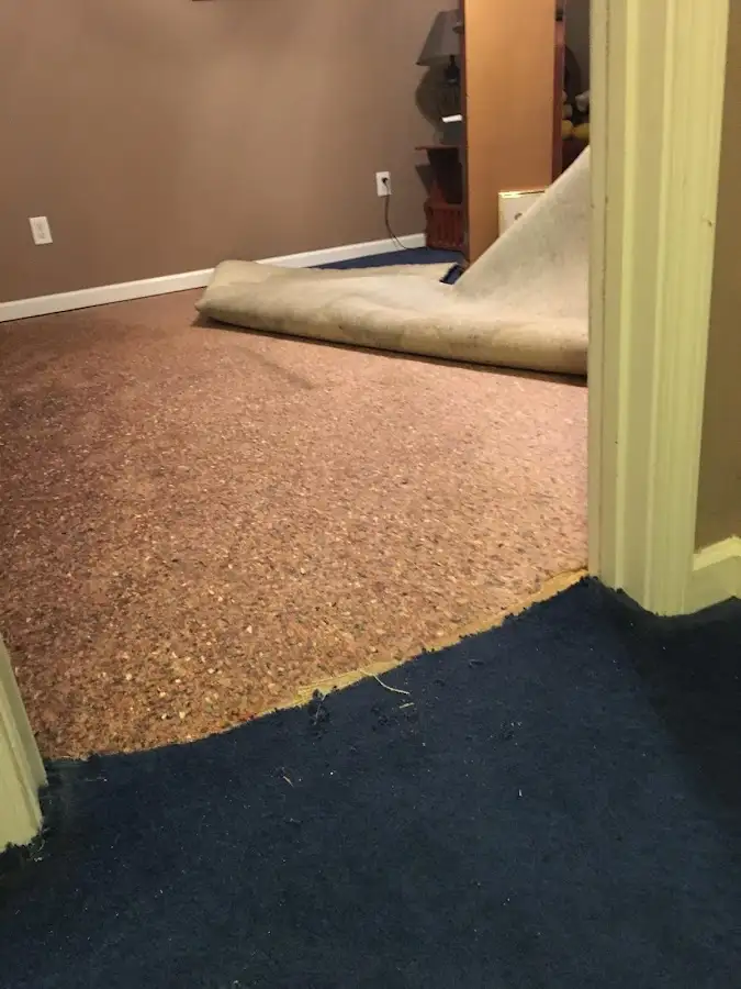 Carpet pad removal revealing water damage during Water Mitigation Services in Garden Grove
